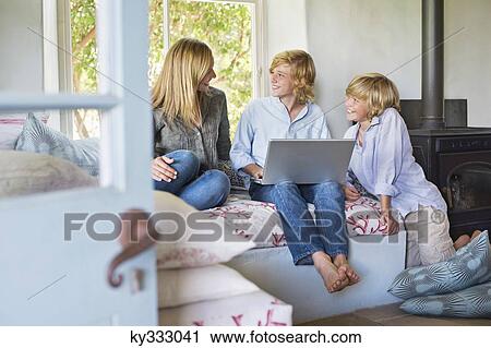 Children and their mother using laptop at house View Large Photo Image Stock Image - Children and their mother using laptop at house. Fotosearch