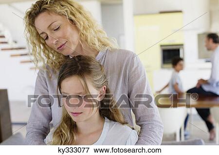 Stock Photo - Close-up of a girl smiling with her mother. Fotosearch