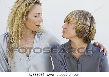 Close-up of a mid adult woman and his son looking at each other View Large Photo Image Stock Image - Close-up of a mid adult woman and his son looking at each other. Fotosearch