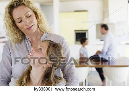 Girl looking at her mother and smiling View Large Photo Image Stock Image - Girl looking at her mother and smiling. Fotosearch