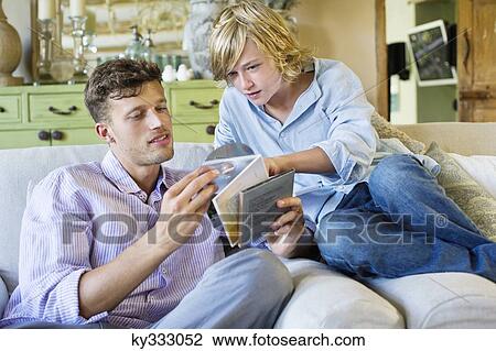 Man and a little boy looking at compact discs View Large Photo Image Stock Image - Man and a little boy looking at compact discs. Fotosearch