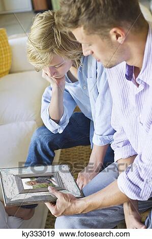 Man and a little boy looking at picture frame View Large Photo Image Stock Photo - Man and a little boy looking at picture frame. Fotosearch