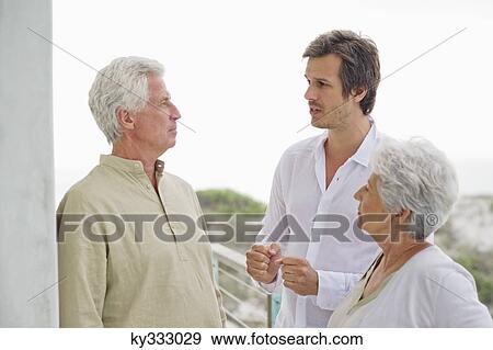 Mid adult man discussing to his parents View Large Photo Image Stock Photo - Mid adult man discussing to his parents. Fotosearch
