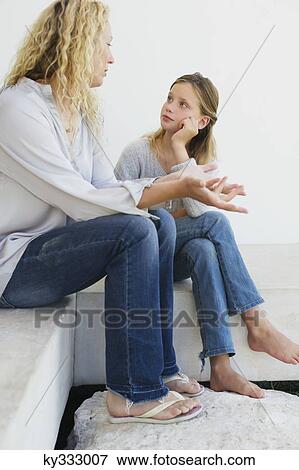 Mid adult woman communicating with her daughter View Large Photo Image Stock Photo - Mid adult woman communicating with her daughter. Fotosearch