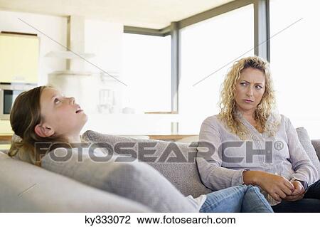 Mid adult woman looking at her daughter View Large Photo Image Stock Image - Mid adult woman looking at her daughter. Fotosearch