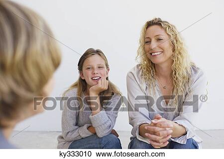 Mid adult woman talking to her son and daughter at home View Large Photo Image Stock Image - Mid adult woman talking to her son and daughter at home. Fotosearch