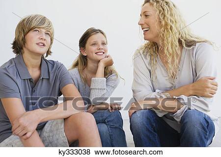 Mid adult woman talking to her son and daughter View Large Photo Image Stock Photo - Mid adult woman talking to her son and daughter. Fotosearch