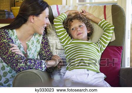 Stock Image - Mother and little boy sitting together at home. Fotosearch