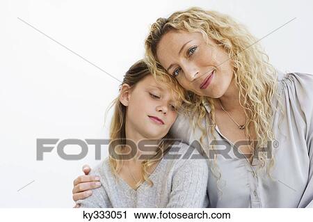 Portrait of a mid adult woman sitting with her daughter View Large Photo Image Stock Image - Portrait of a mid adult woman sitting with her daughter. Fotosearch