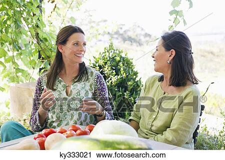 Senior woman sitting with her daughter at home View Large Photo Image Stock Image - Senior woman sitting with her daughter at home. Fotosearch