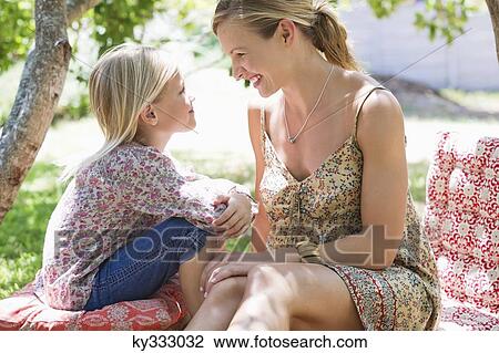 Side profile of mother and a little girl looking to each other outdoors View Large Photo Image Stock Image - Side profile of mother and a little girl looking to each other outdoors. Fotosearch