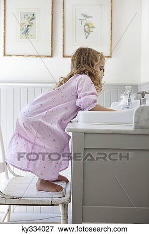 Cute little girl bending over bathroom sink View Large Photo Image Stock Photo - Cute little girl bending over bathroom sink. Fotosearch