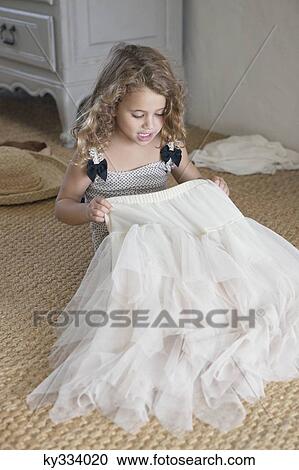 Cute little girl getting dressed like her mother in oversized clothes View Large Photo Image Stock Image - Cute little girl getting dressed like her mother in oversized clothes. Fotosearch