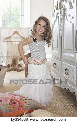 Cute little girl getting dressed like her mother in oversized clothes View Large Photo Image Stock Photo - Cute little girl getting dressed like her mother in oversized clothes. Fotosearch
