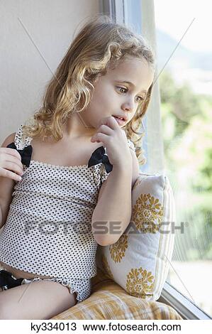 Cute little girl looking out from a window View Large Photo Image Stock Image - Cute little girl looking out from a window. Fotosearch