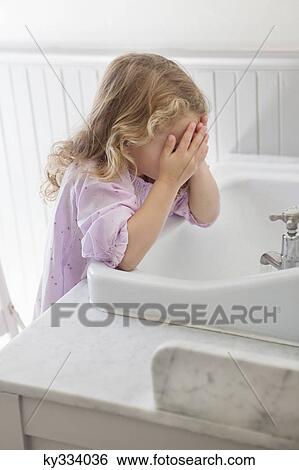 Cute little girl washing face in bathroom sink View Large Photo Image Stock Photograph - Cute little girl washing face in bathroom sink. Fotosearch