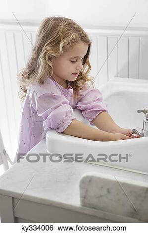 Cute little girl washing hands in bathroom sink View Large Photo Image Stock Photograph - Cute little girl washing hands in bathroom sink. Fotosearch