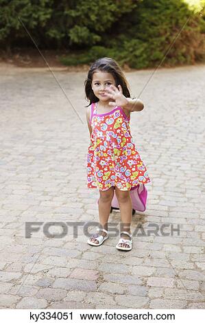 Girl carrying her luggage and waving hand View Large Photo Image Stock Image - Girl carrying her luggage and waving hand. Fotosearch