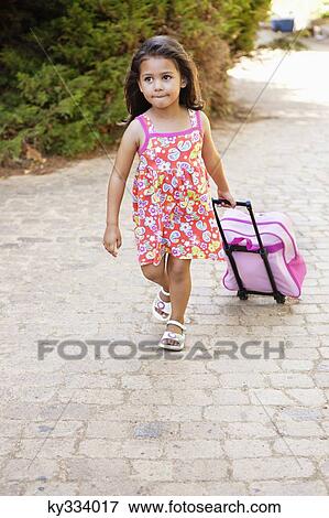 Little girl pulling a bag View Large Photo Image Stock Photo - Little girl pulling a bag. Fotosearch