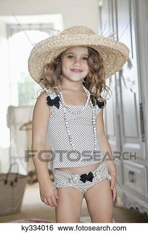 Portrait of a little girl dressed like her mother in oversized accessories View Large Photo Image Stock Photograph - Portrait of a little girl dressed like her mother in oversized accessories. Fotosearch