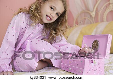 Portrait of a little girl playing with a box View Large Photo Image Stock Image - Portrait of a little girl playing with a box. Fotosearch