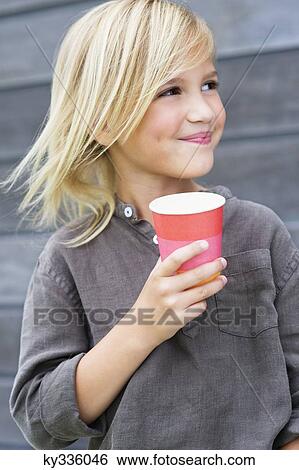 Girl holding a coffee cup and smiling View Large Photo Image Stock Photograph - Girl holding a coffee cup and smiling. Fotosearch