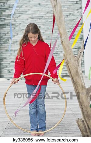 Girl holding a plastic hoop View Large Photo Image Stock Photograph - Girl holding a plastic hoop. Fotosearch