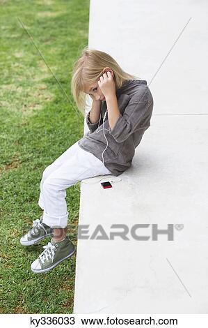 Girl listening to music with an MP3 player View Large Photo Image Stock Image - Girl listening to music with an MP3 player. Fotosearch