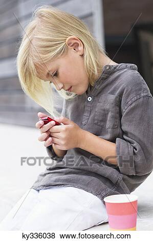 Girl using an mp3 player View Large Photo Image Stock Photo - Girl using an mp3 player. Fotosearch