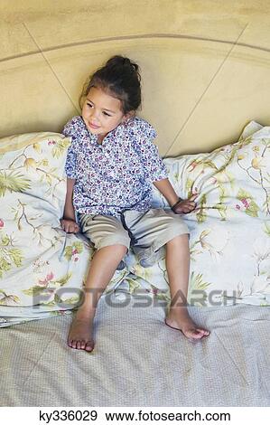 Little girl sitting on couch View Large Photo Image Stock Photo - Little girl sitting on couch. Fotosearch