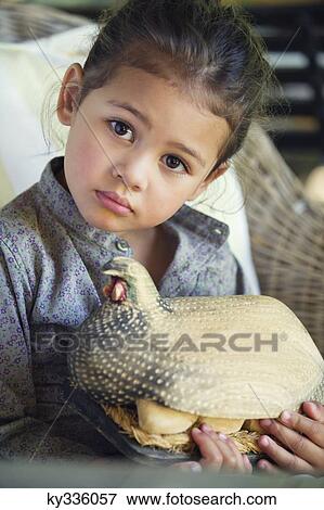 Portrait of a little girl holding model of turkey View Large Photo Image Stock Photo - Portrait of a little girl holding model of turkey. Fotosearch