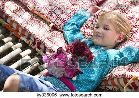 Portrait of a little girl lying in hammock with a toy View Large Photo Image Stock Photograph - Portrait of a little girl lying in hammock with a toy. Fotosearch