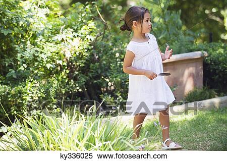 Side profile of a little girl walking in the garden View Large Photo Image Stock Photography - Side profile of a little girl walking in the garden. Fotosearch