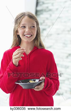 Smiling girl eating food View Large Photo Image Stock Photography - Smiling girl eating food. Fotosearch