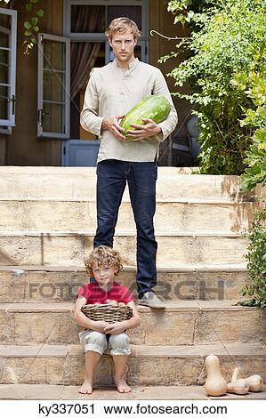 Father and son carrying fruits View Large Photo Image Stock Image - Father and son carrying fruits. Fotosearch