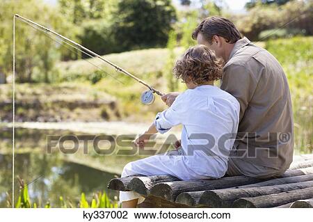 Father and son fishing in a lake View Large Photo Image Stock Image - Father and son fishing in a lake. Fotosearch