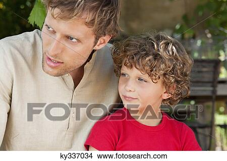 Picture - Father and son looking away. Fotosearch