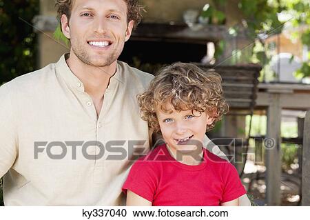 Stock Image - Portrait of a father and son smiling. Fotosearch