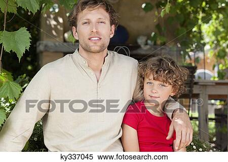 Portrait of a father and son with arm around View Large Photo Image Stock Photography - Portrait of a father and son with arm around. Fotosearch