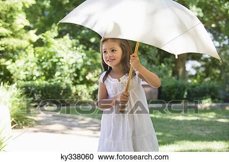 Cute little girl holding an umbrella View Large Photo Image Stock Image - Cute little girl holding an umbrella. Fotosearch