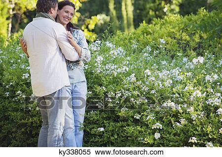 Happy mature couple romancing in a garden View Large Photo Image Stock Photography - Happy mature couple romancing in a garden. Fotosearch