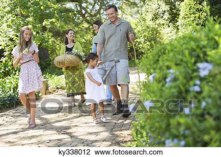 Stock Image - Happy multi generation family enjoying in the garden. Fotosearch