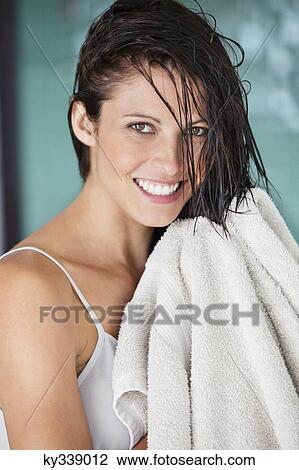Portrait of a woman drying her hair with a towel View Large Photo Image Stock Image - Portrait of a woman drying her hair with a towel. Fotosearch