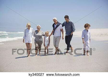 Stock Photo - Family enjoying on the beach. Fotosearch
