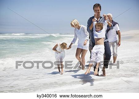 Family enjoying on the beach View Large Photo Image Stock Photograph - Family enjoying on the beach. Fotosearch
