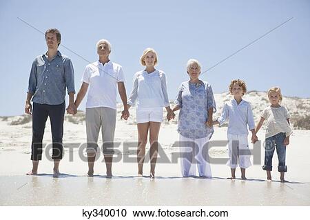 Family standing on the beach View Large Photo Image Stock Image - Family standing on the beach. Fotosearch