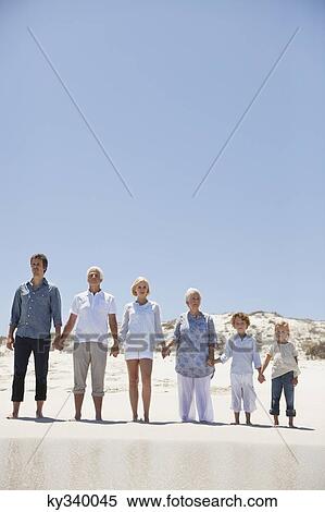 Family standing on the beach View Large Photo Image Stock Photography - Family standing on the beach. Fotosearch