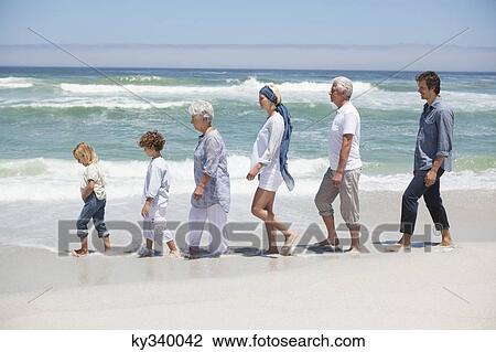 Family walking in a row at beautiful beach with kids View Large Photo Image Stock Image - Family walking in a row at beautiful beach with kids . Fotosearch