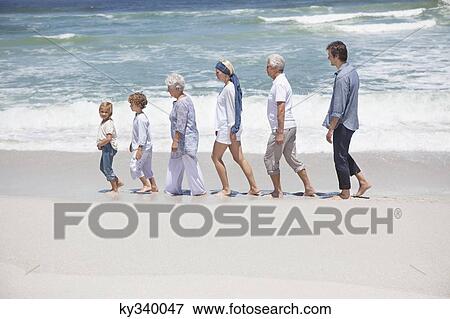 Family walking in row with kids at beach View Large Photo Image Stock Photo - Family walking in row with kids at beach. Fotosearch