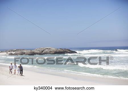 Picture - Family walking on the beach. Fotosearch